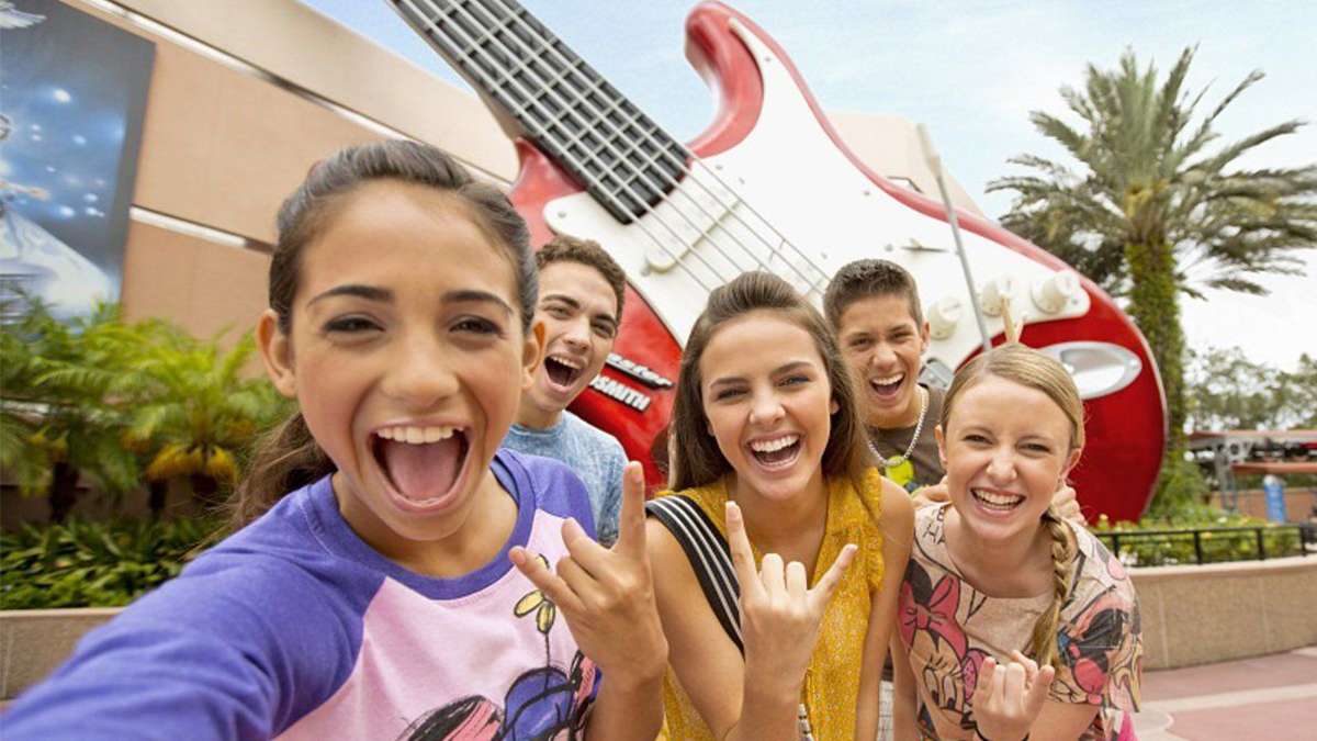 family standing in front of hollywood rock n roller coaster